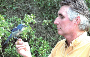 Jon Thaxton holds a bird in his hand