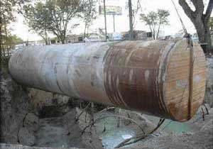 A failed double-wall tank is removed, highlighting the need for annual inspections. 