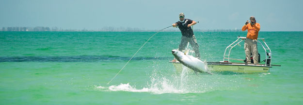 Angler Joe Costadura tangles with a giant tarpon while Capt. Nick Angelo records the battle. 				       Photo by Bryon Chamberlin 