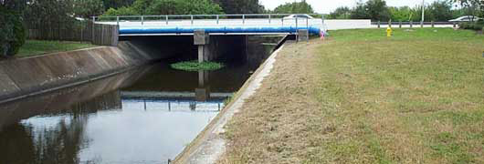 Cross Bayou Canal, built in the early 1900s, bisects Pinellas County. Parts of it are lined with concrete, others are more natural but Brazilian pepper trees are a problem. Photo courtesy Pinellas County.